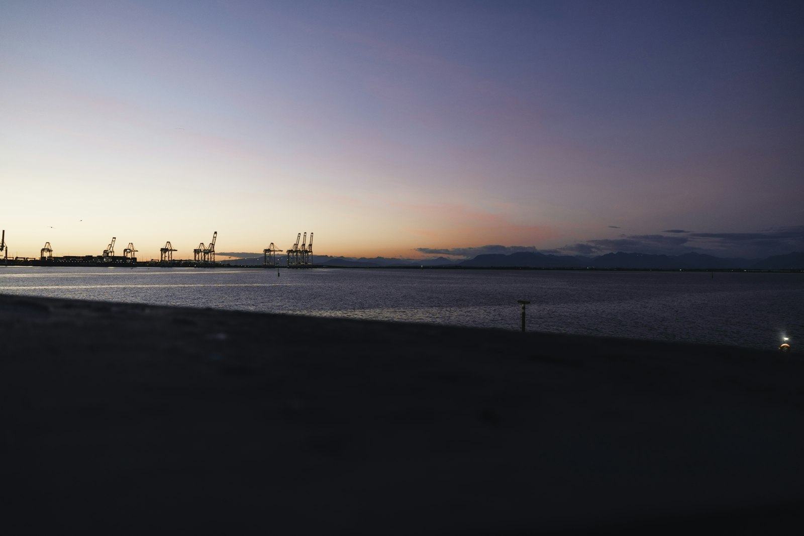 Harbor cranes at dusk
