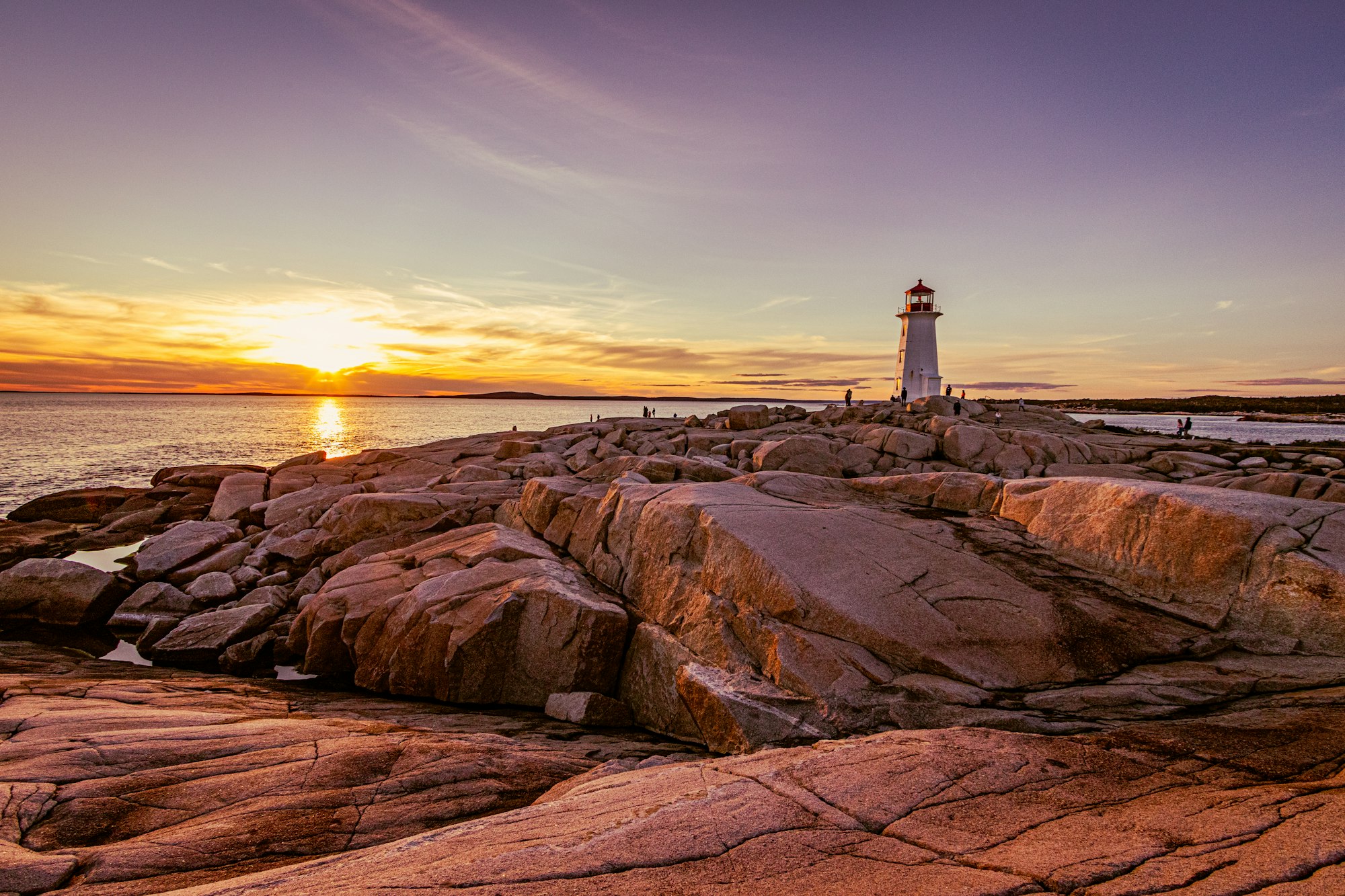 Lighthouse on a rocky coast at dusk